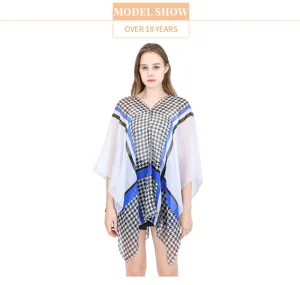 Detailed visual view of a lightweight houndstooth print sunscreen shawl worn on a model