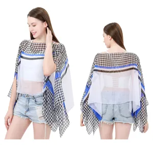 Front and back view of a sheer houndstooth summer sun protection shawl in blue and white
