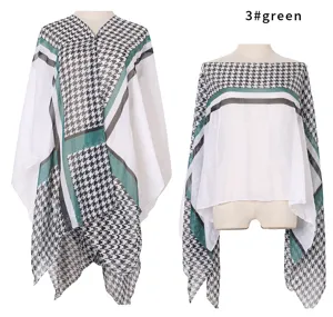 Detail view of the elegant green houndstooth summer sun protection shawl on a mannequin