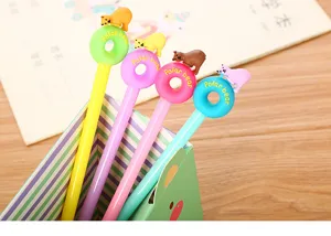 Detail view of four colorful cartoon polar bear donut gel pens in a green desk holder