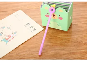 Close-up of a purple neutral pen with a cute polar bear figurine on a doughnut top