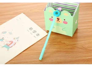 Cute cartoon polar bear donut gel pen resting on a desk with a notebook backdrop