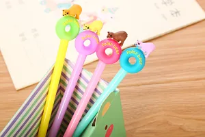 Close-up view of colorful cartoon polar bear and donut gel pens displayed in a holder.