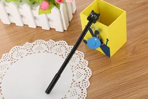 Detail view of a cute black cat topper on a sleek black cartoon stationery gel pen