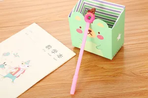Close-up detail of a cute pink gel pen featuring a polar bear and donut topper design