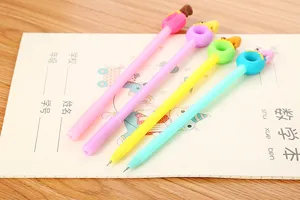 Detail of cute polar bear donut toppers on colorful stationery pens