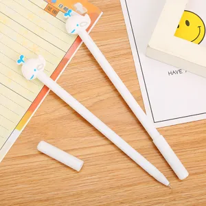 Set of two cute whale-shaped gel pens for students displayed on a wooden desk surface