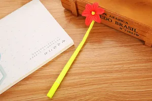 Detailed view of a cute red flower topper on a bright lime green cartoon gel pen