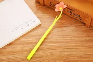 Detail of cute yellow gel pen with pink soft glue flower topper decoration