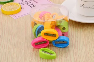 Close-up of vibrant candy-colored oval pencil sharpeners displayed in a clear plastic jar