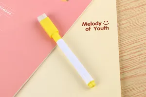 Detailed close-up of a small yellow whiteboard marker with a built-in eraser cap