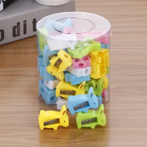 Cute colorful rabbit-shaped pencil sharpeners stored in a clear cylindrical desktop container