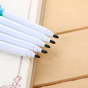 Pack of five professional white dry-erase markers with fine black tips on a lined notebook