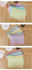 Multiple colorful A4 mesh zipper file bags displayed on a wooden table detail view