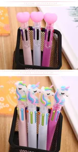 Close-up detail of cute heart and unicorn topped multi-color ballpoint pens for journaling