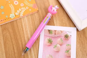 Close-up detail of the pink unicorn moon topper on a multi-color 6-in-1 ballpoint pen