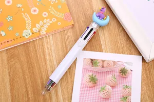Close-up detail of a creative 6-color ballpoint pen with cute cartoon unicorn topper