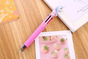 Cute pink unicorn 6-in-1 multi-color ballpoint pen for journaling on wooden desk