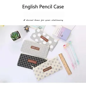Macro view of four oxford cloth pencil cases with stylish polka dot and grid patterns