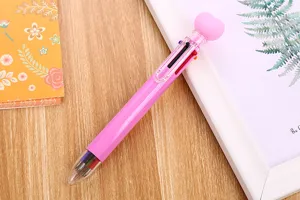 Detail view of pink 6-color heart top ballpoint pen for journaling and school supplies