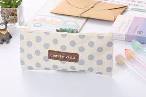 Close-up of a cream and grey polka dot pencil case made of durable oxford fabric