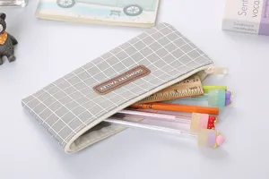Detail view of a grey grid Oxford cloth pencil case filled with cute colorful stationery