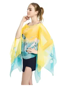 Lightweight chiffon floral print shawl with button closure worn as a summer poncho