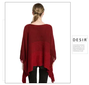 Back view of red cashmere-like knit poncho with gold threads and stylish fringes