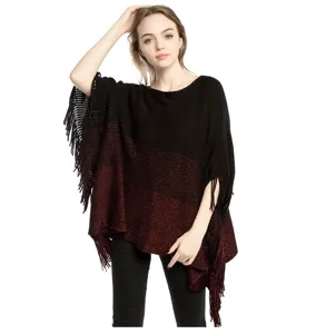 Detailed view of the black and red color block knitted poncho with fringe embellishments