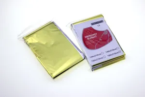 Coperte termiche di emergenza in oro e argento per sopravvivenza all'aperto e campeggio.
