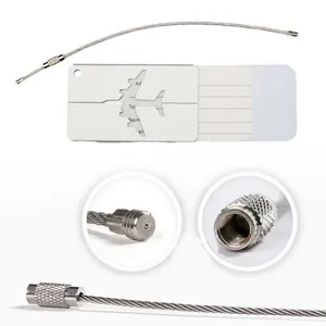 Metal luggage tag detail view, aluminum card holder with steel wire cable loop and connector.