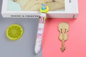Detailed macro view of 10-color ballpoint pen with unicorn and moon topper décor.
