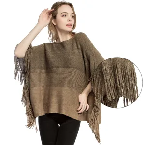 Women's knit poncho shawl with fringe details and shimmering gold wire yarn