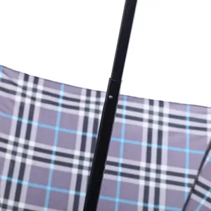 Detailed view of the black metal shaft and classic plaid pattern folding umbrella canopy.