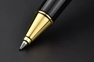 Close-up detail of luxury black and gold metal signature pen nib, fine craftsmanship and heavy feel.