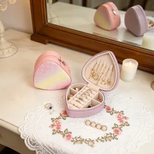 Heart-shaped mini jewelry travel organizer cases in a romantic and sweet vanity setting