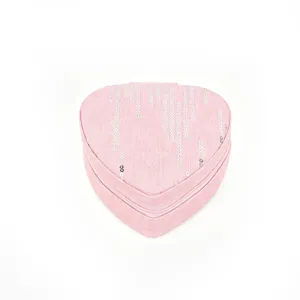 Detailed close-up view of a pink heart-shaped jewelry box with vertical silver sequin stripes.