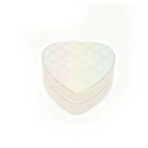 Close-up detail of a heart-shaped mini jewelry box featuring a pastel checkered pattern lid