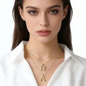 Gold-plated letter pendant double layer necklace with sparkling cubic zirconia details.