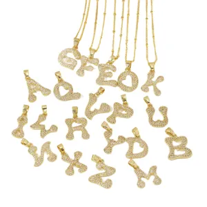 Gold-plated iced out bubble initial letter pendant necklace, sparkling cubic zirconia jewelry.