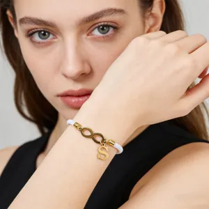 White woven rope bracelet with gold infinity charm and letter S pendant for couples fashion.