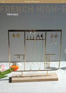 Detailed view of gold jewelry organizer with wood base holding earrings and necklaces