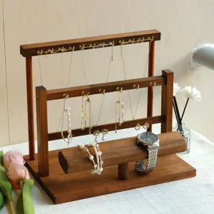 Tiered walnut wood jewelry stand with hooks for necklaces and watch bar display