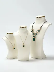Three-tiered white leather necklace display busts with elegant gold-rimmed detailing