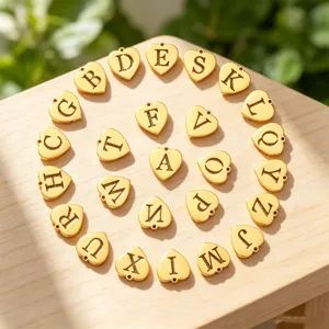 Gold heart letter charms detail shot, stylish initial alphabet pendant for DIY jewelry making.