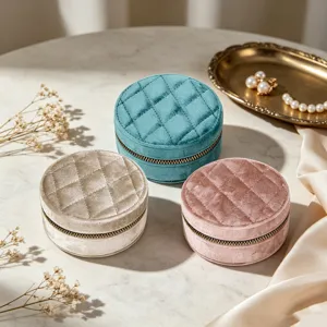 Round quilted velvet jewelry storage boxes in three elegant colors on a marble tabletop