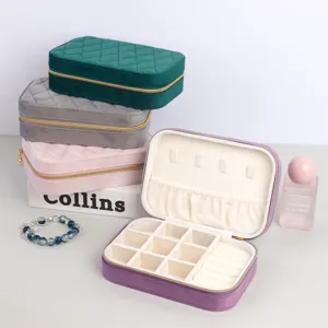 Velvet travel jewelry box organizer with quilted design and multiple compartments for storage