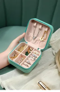 Internal view of mint green portable jewelry travel case with organized compartments