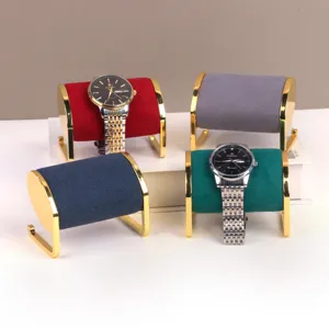 Set van fluwelen horlogestandaards met gouden metalen frames in vier levendige kleuren.