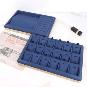 Close-up detail of blue PU leather jewelry display trays with elegant gold trim